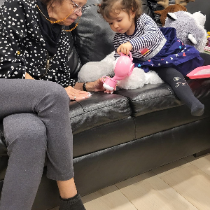 Elva with her granddaughter doing pretend tea time.